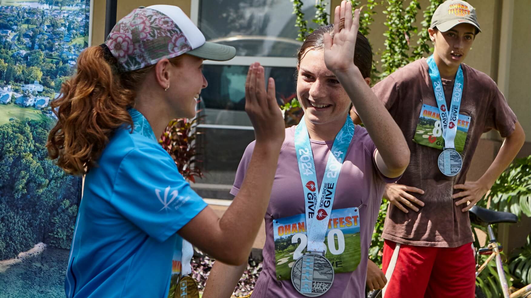 Youth high-five after completing a race event.
