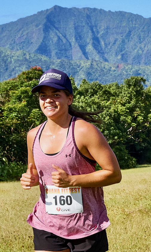 Smiling woman runner at Ohana FitFest mountain race